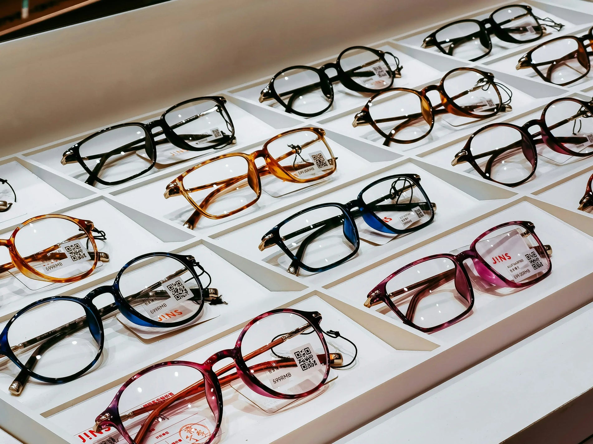 Beautiful cat eye glasses in various colors neatly displayed on a store shelf